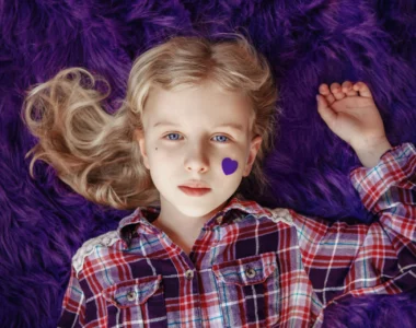 girl lying in purple cloth wearing purple checkered top