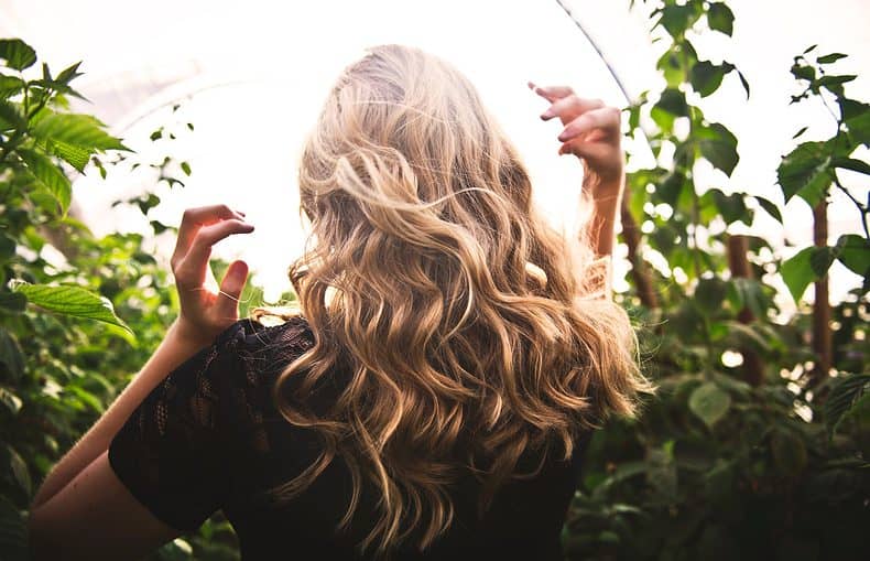 beautiful haired woman sorrounded with foliage