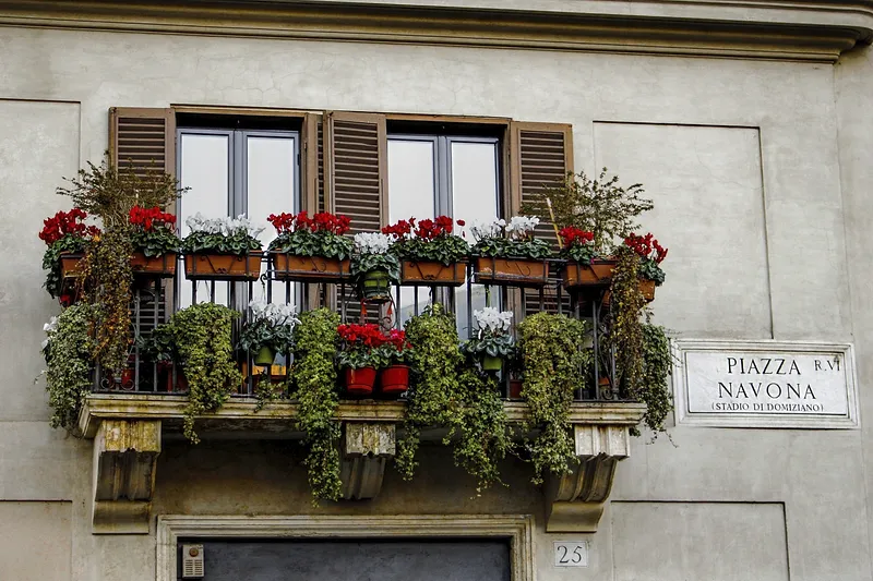 small balcony with railing planters with plants