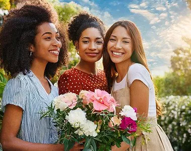 3 women with flowers on international womens day